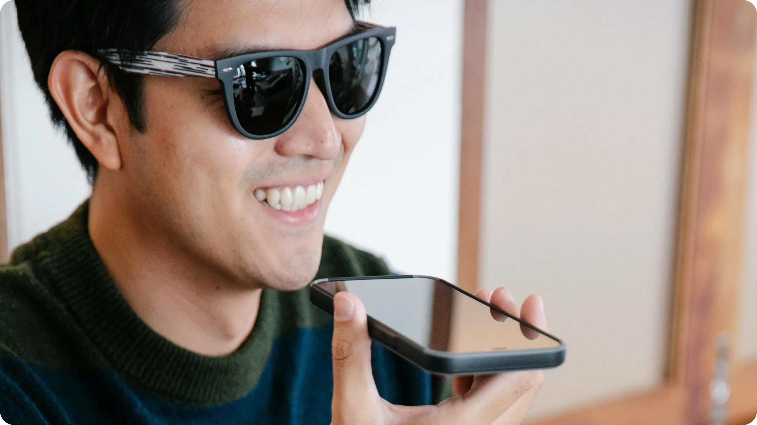 Man operating his phone via voice-to-text.