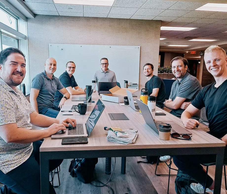 Three people in front of a Livefront logo