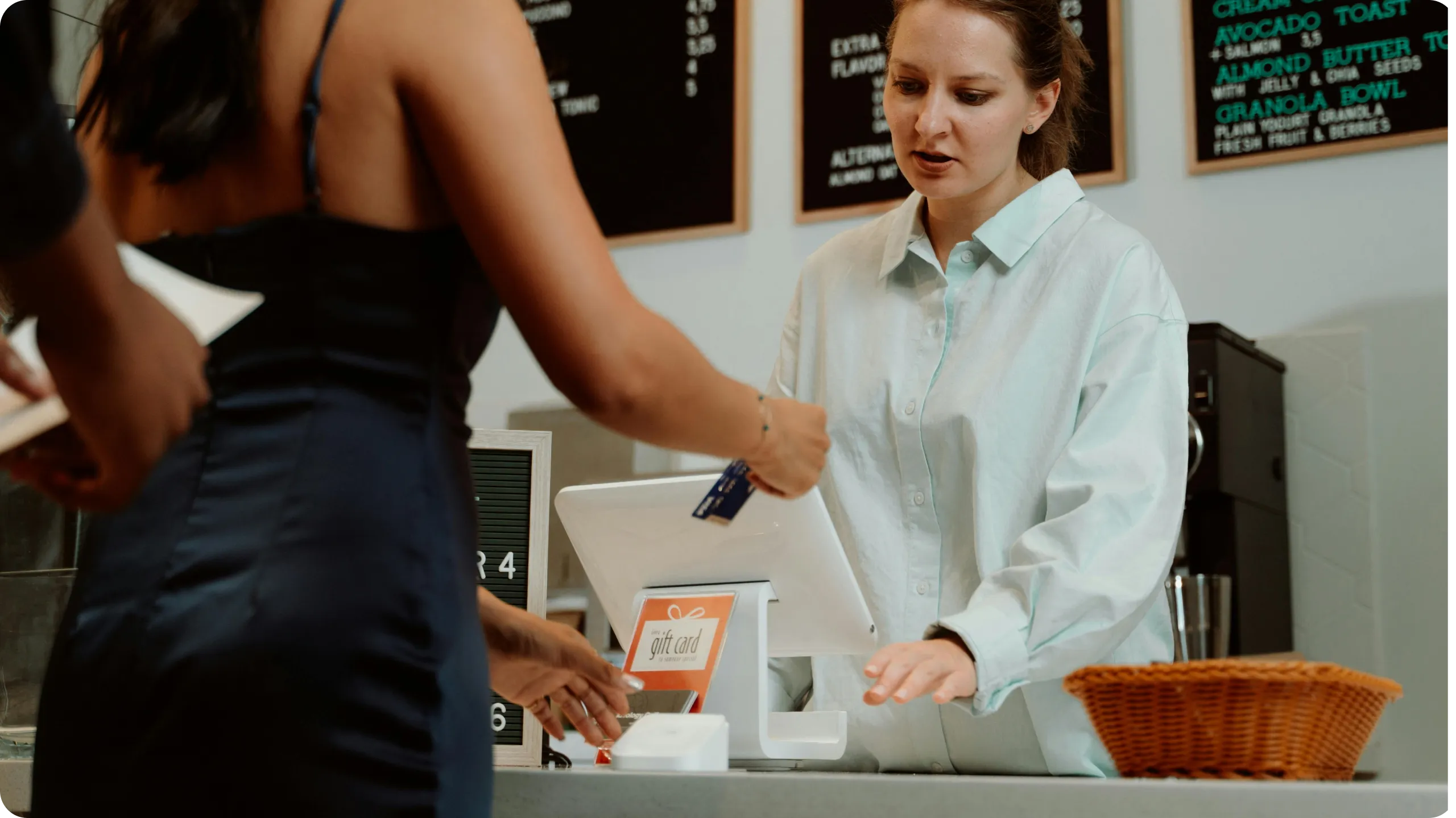 Woman paying at a cafe.