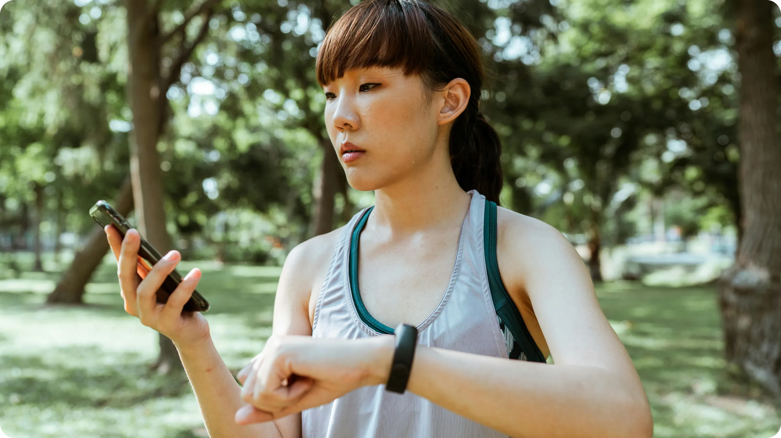 Woman monitoring workout data via fitness tracker.