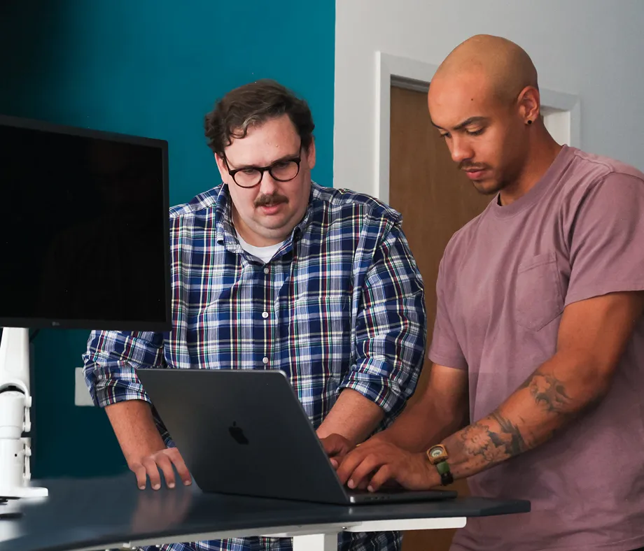 Two people looking at a computer together