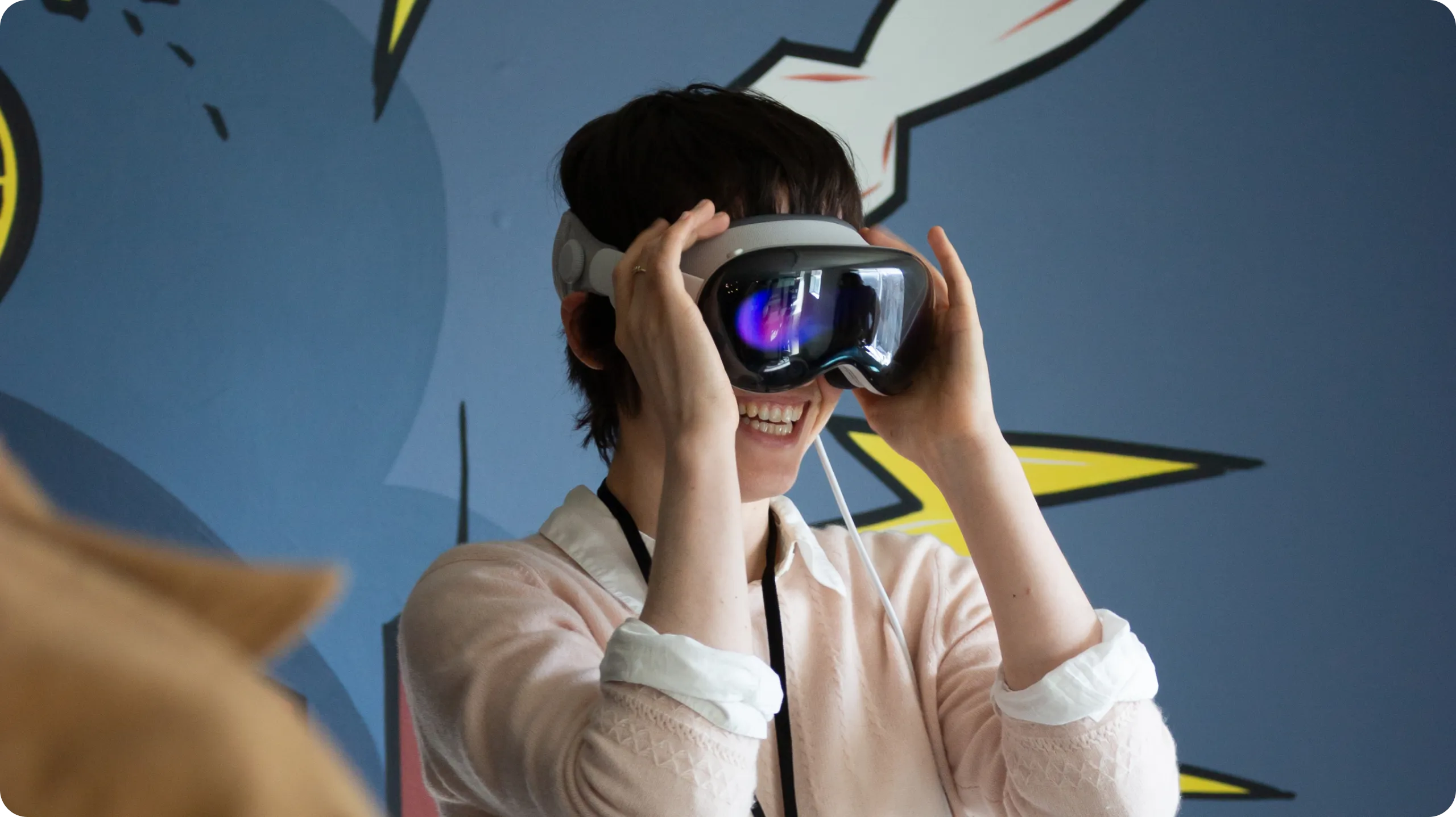 A person smiling while wearing an Apple Vision Pro.