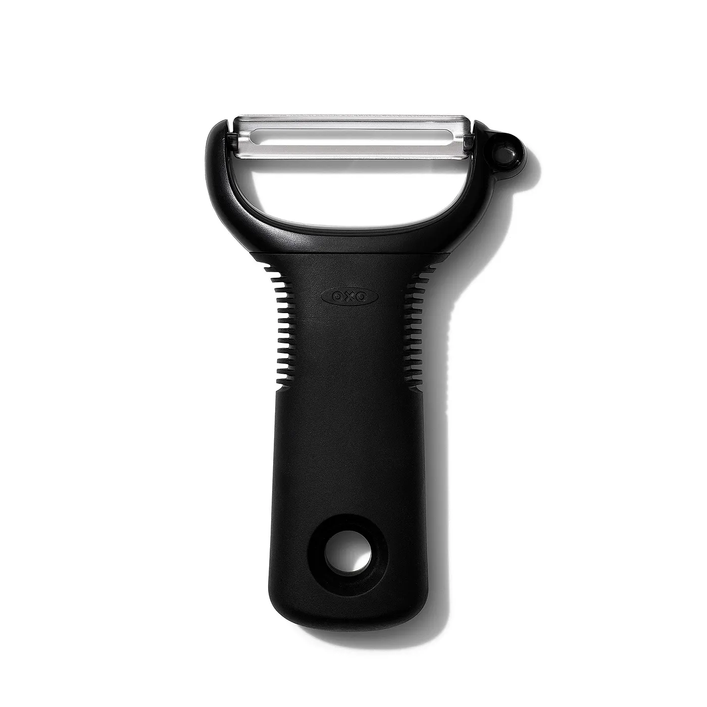 A photograph of the OXO Good Grips vegetable peeler. It has a thick, black rubber/plastic handle with fins.